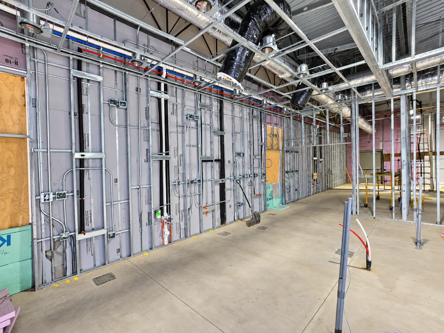 Metal-stud partitions defining an interior under construction